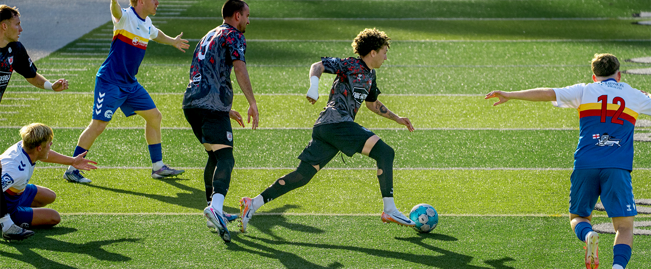 Hickory FC player, Amare Lucas, advancing the ball downfield during match against Asheville City SC on July 11, 2026.